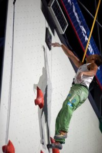 Sean McColl hitting the timer at the top the speed climbing route in Paris 2016