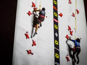 Two Climbers racing on Speed wall clipped in to Perfect Descent Auto Belays