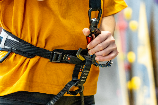 Climber connecting Perfect Descent Auto Belay to their harness